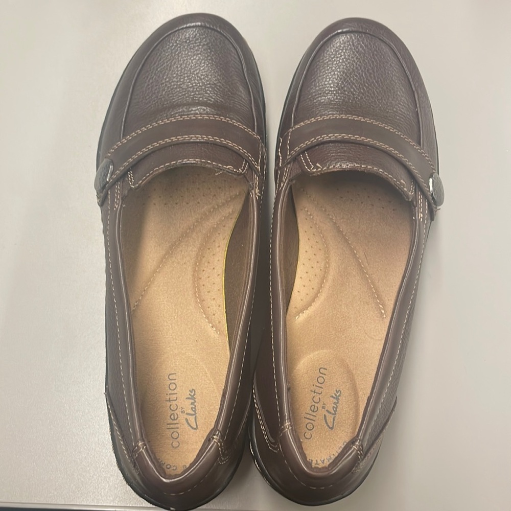 Size 7.5 brown slip on Clarks. Never worn, still have box.